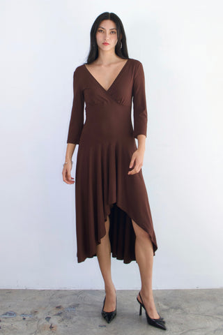 Woman wearing a brown dress against a white background